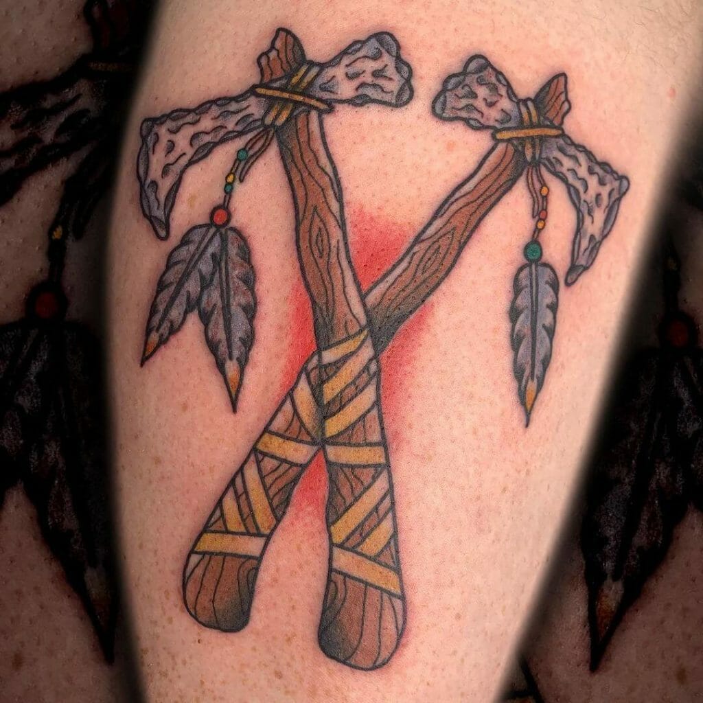 Spectacular cross ax tattoo