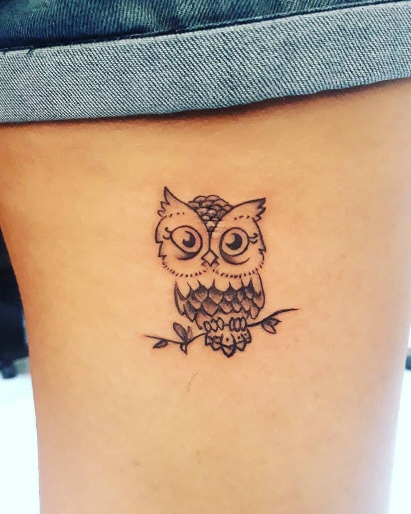 The cute little owl tattoo on a tree