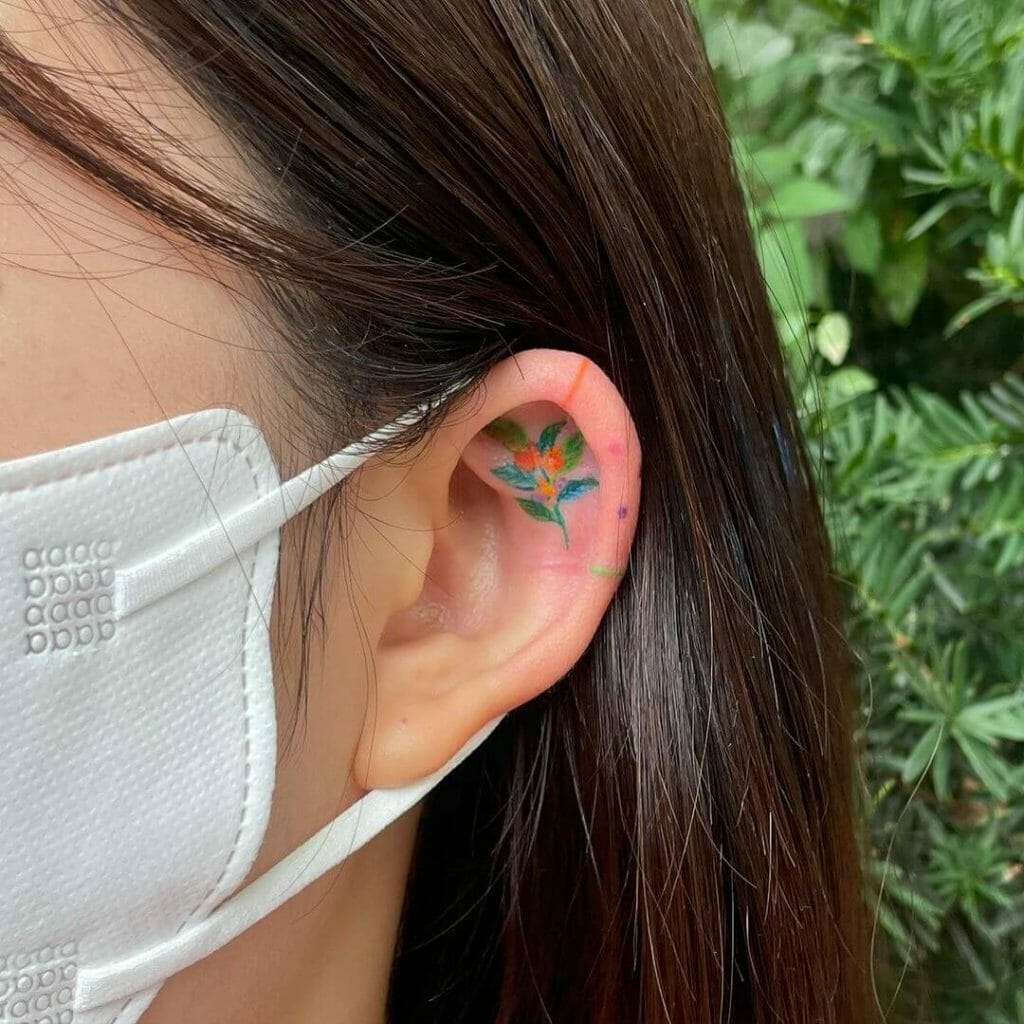 Tiny colorful floral ear tattoos