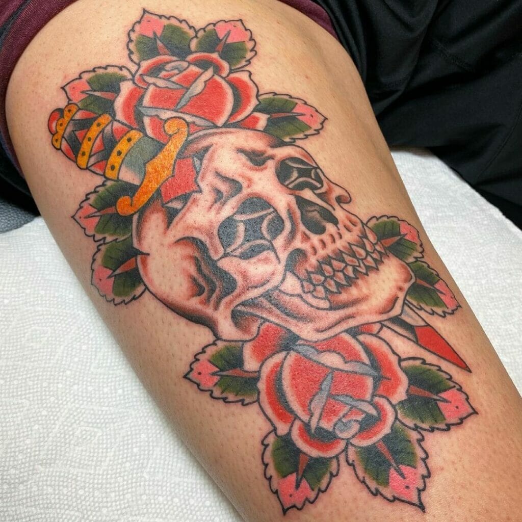 Traditional skull and dagger tattoo with blooming rose