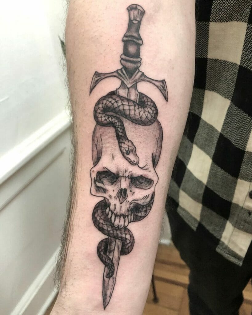 Traditional skull and dagger tattoo wrapped by the snake