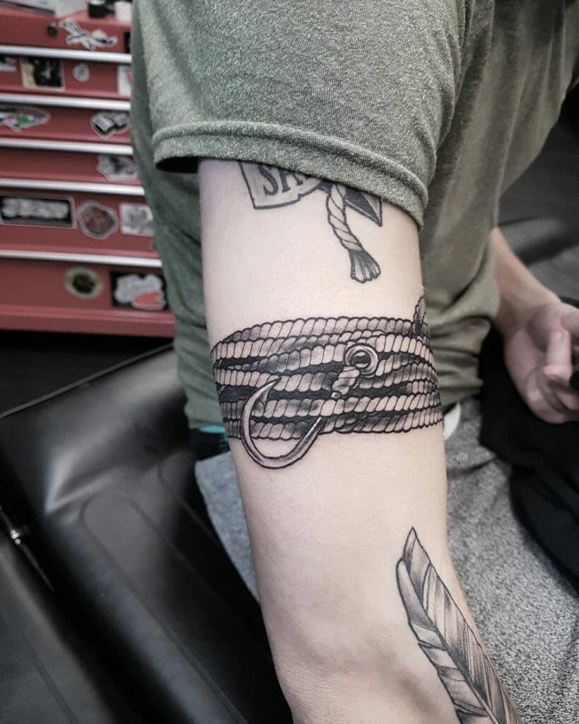 Wrap around fishhook tattoo