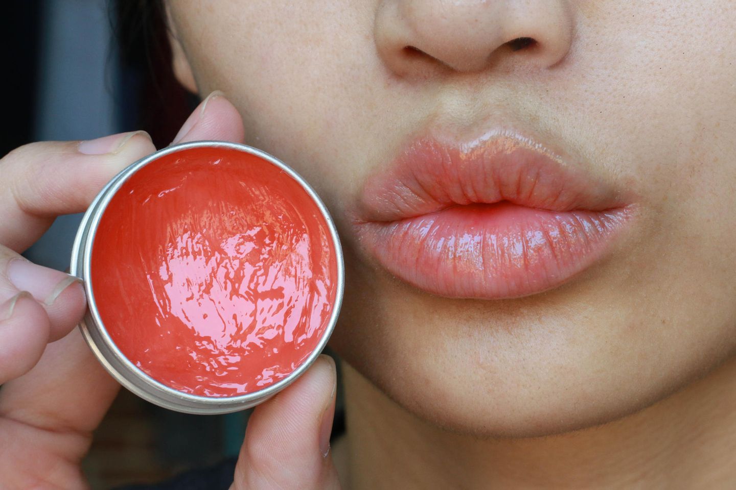 Woman uses lip balm, lip balm