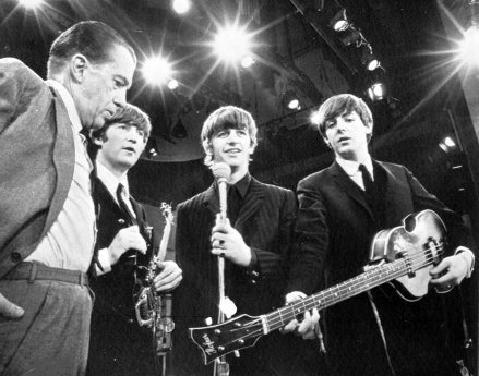 American television presenter Ed Sullivan, left, talks to three members of British pop group The Beatles during a rehearsal for their appearance on his television show in New York February 8, 1964. From left: Sullivan, John Lennon, Ringo Starr and Paul McCartney.  George Harrison, the fourth member of the group, missed the rehearsal due to illness.  (AP photo)