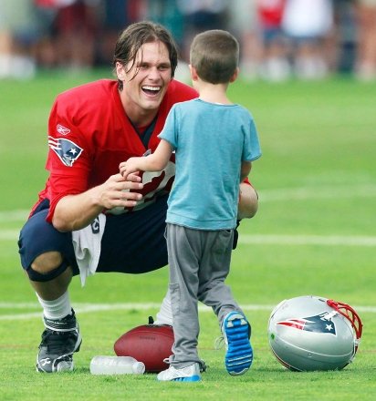 Tom Brady Tom Brady of the New England Patriots greets his son Jack on the field after NFL football training camp at Foxborough, Mass Patriots Camp Football, Foxborough, USA